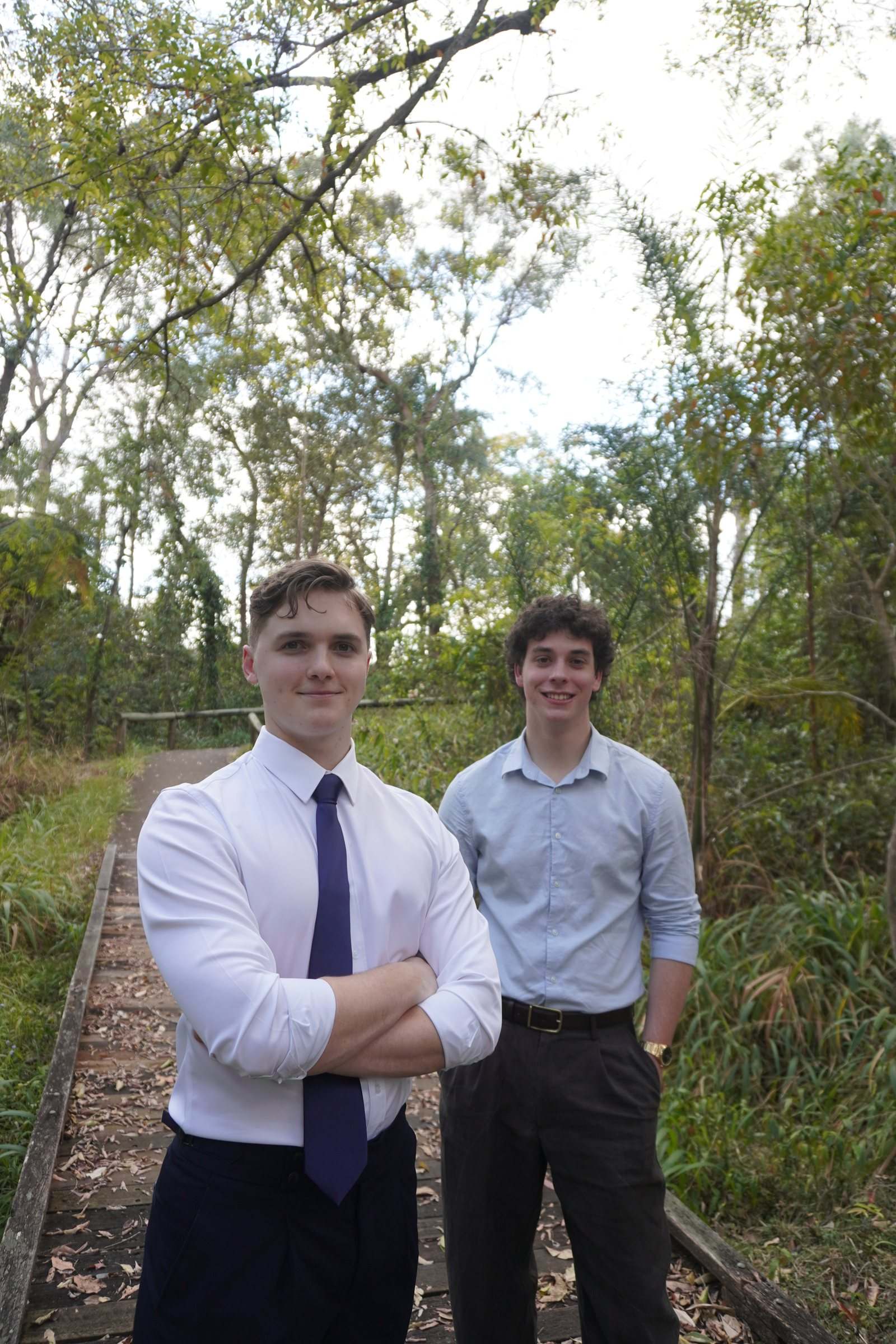 Zeek and Levi standing on a timber boardwalk through bushland