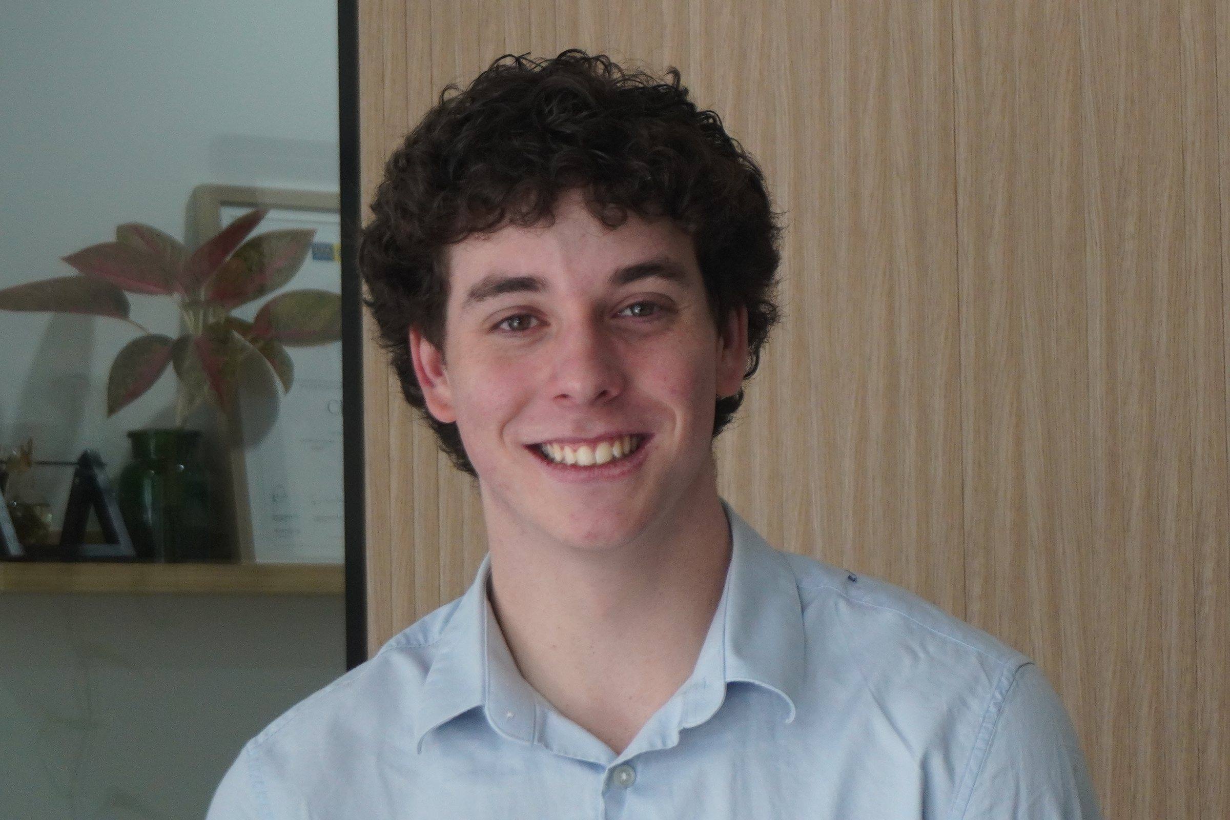 Levi Zimmerman, smiling, in a light-blue shirt
